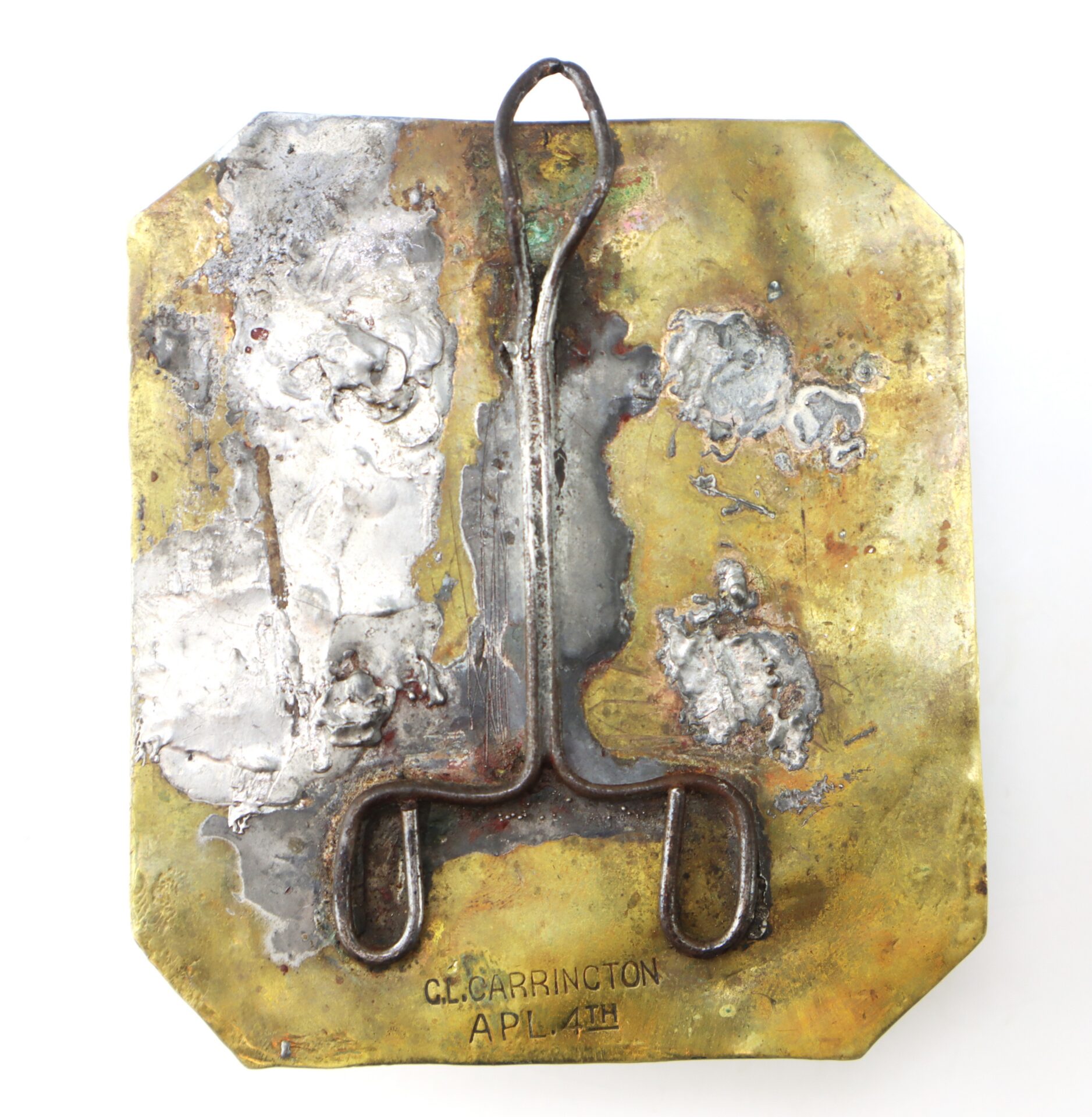 A square brass plaque with welded metal and tarnished areas. An abstract metal shape is attached, and the bottom is stamped “CL. CARRINGTON AP. 14TH.”.