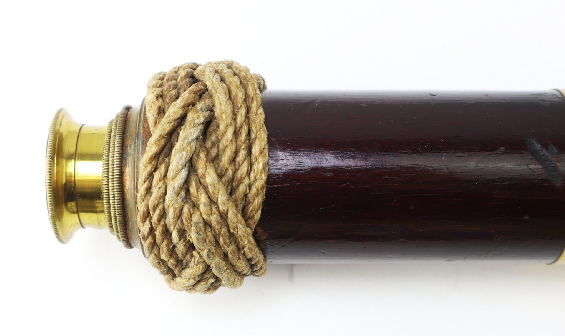A brass and wood telescope wrapped with thick rope near the eyepiece, shown against a plain white background.