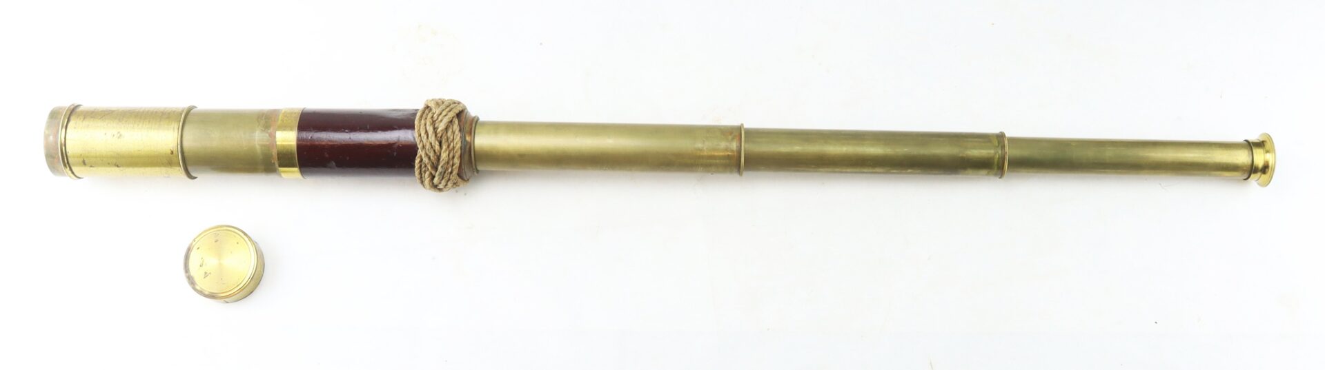 Brass and wood antique telescope with a rope detail, shown fully extended next to its round brass lens cap on a white background.
