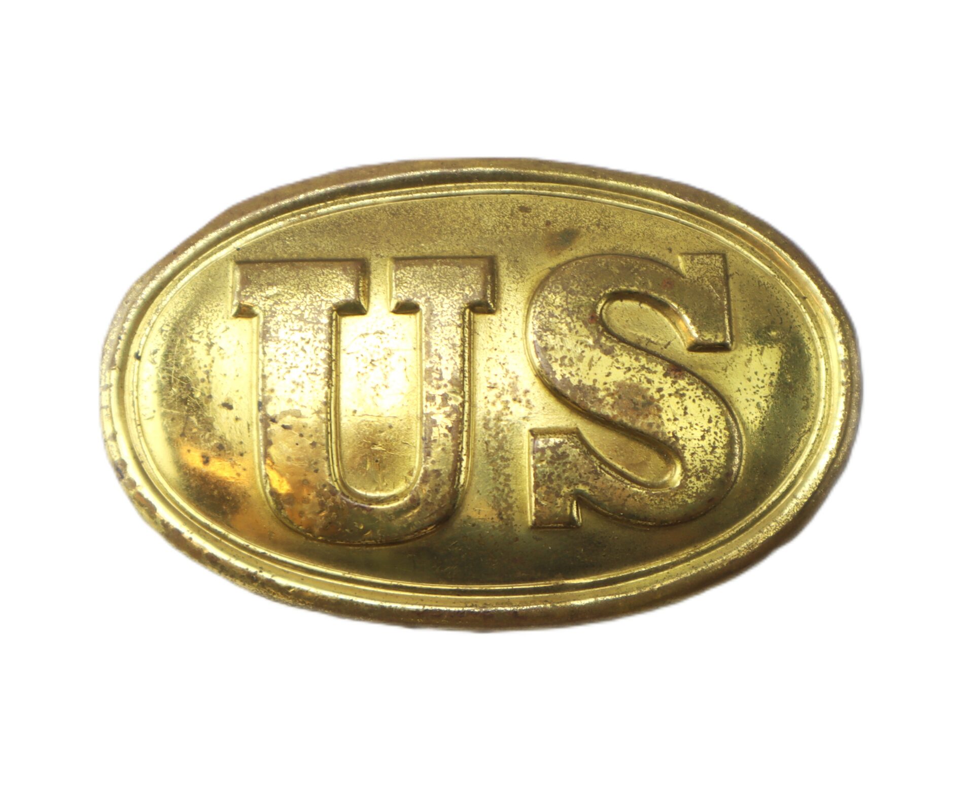 A worn, oval-shaped brass belt buckle with the raised letters “US” on the front, viewed against a white background.