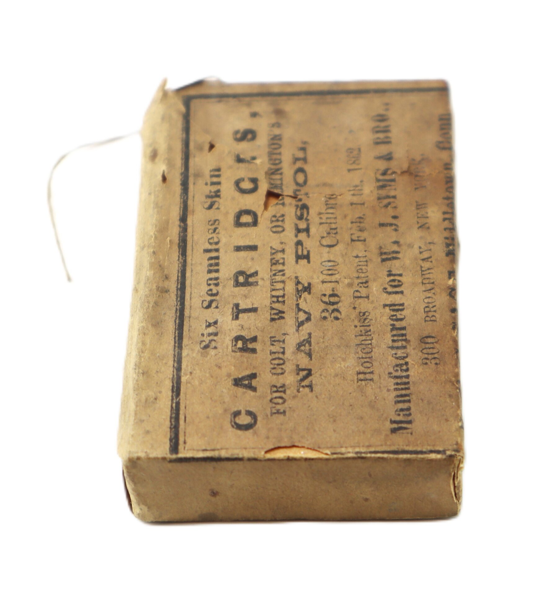 A worn, rectangular box labeled “CARTRIDGES for Colt, Whitney or Remington Navy Pistol, .36 Calibre,” made by J. Ames & Co. with a string attached on one side.