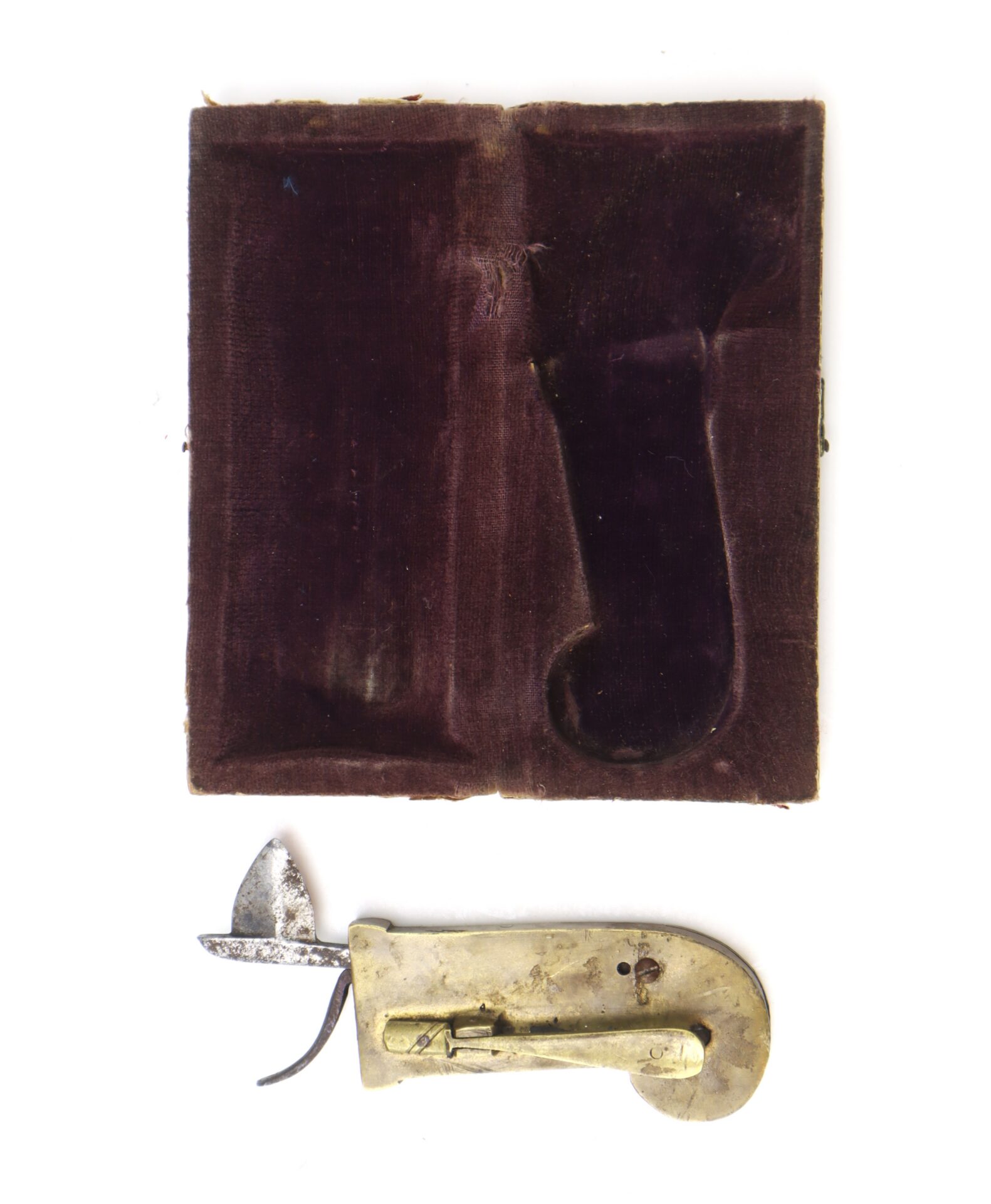 Below is the AUTO-DRAFT (Copy), a vintage brass and steel fleam for bloodletting, displayed alongside its open velvet-lined case with a shaped insert.