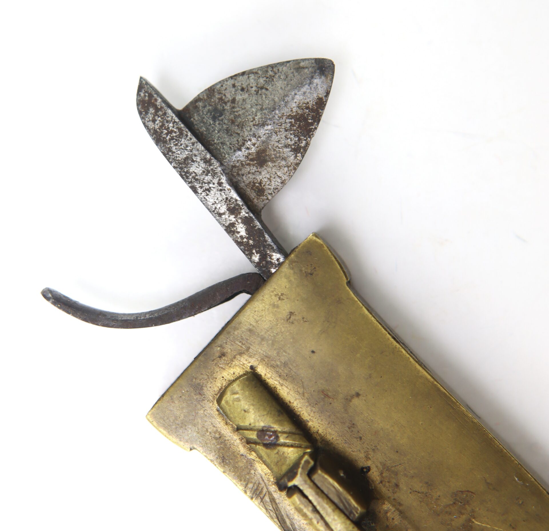 Close-up of the AUTO-DRAFT (Copy) vintage folding knife featuring a brass handle and a partially opened, rusted blade against a white background.