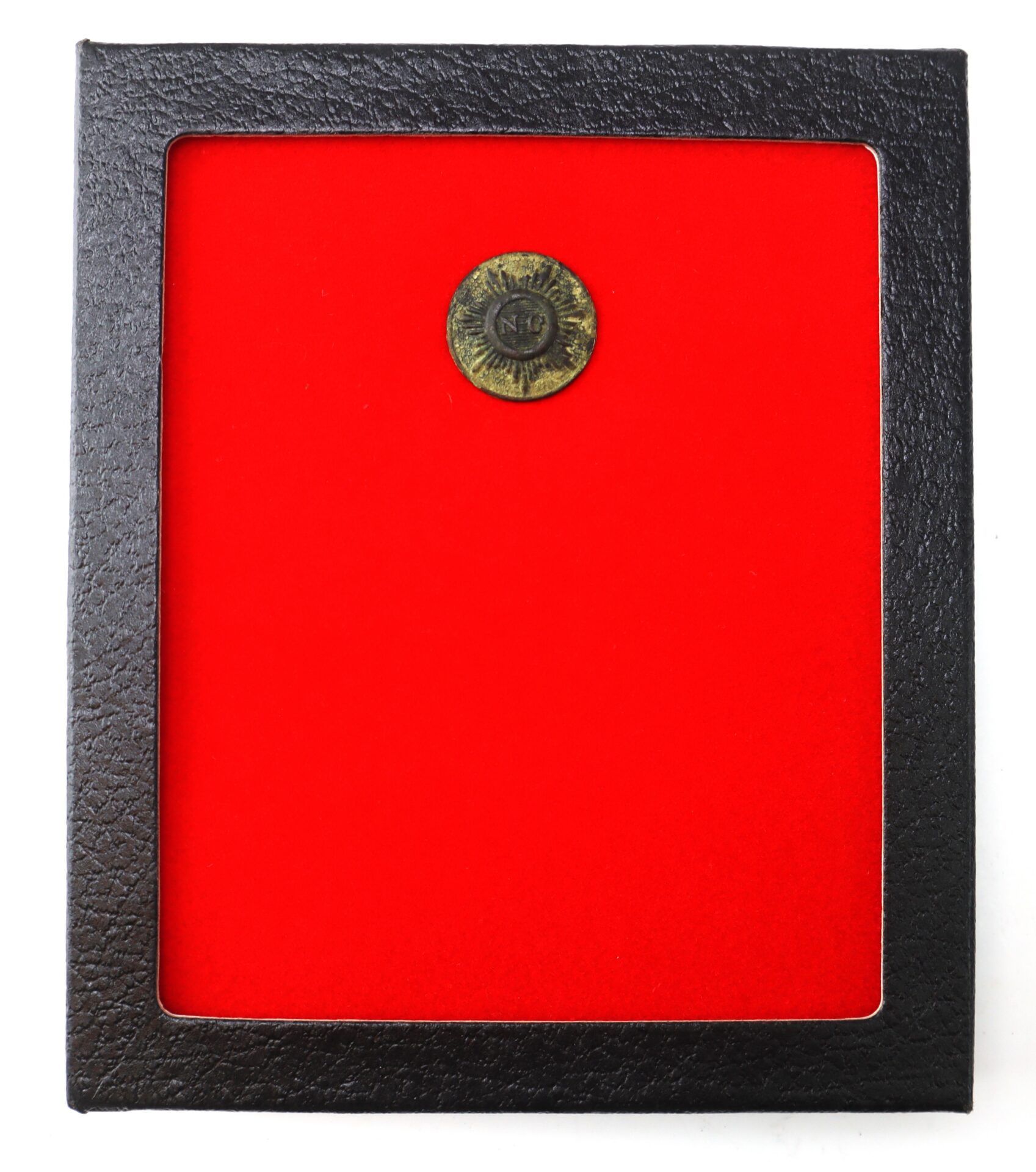 A small round coin labeled “N9” displayed on a bright red background inside a black frame.