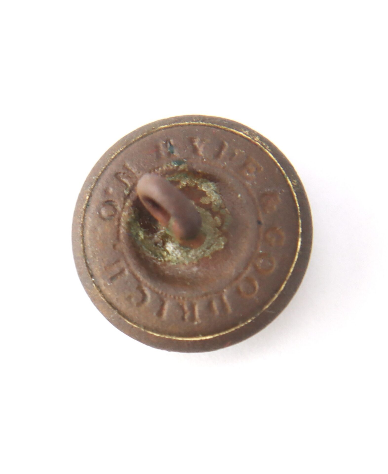 A round Mississippi Cavalry Button made of rusty metal, featuring a loop shank and embossed lettering around the edge, shown from the back against a white background.
