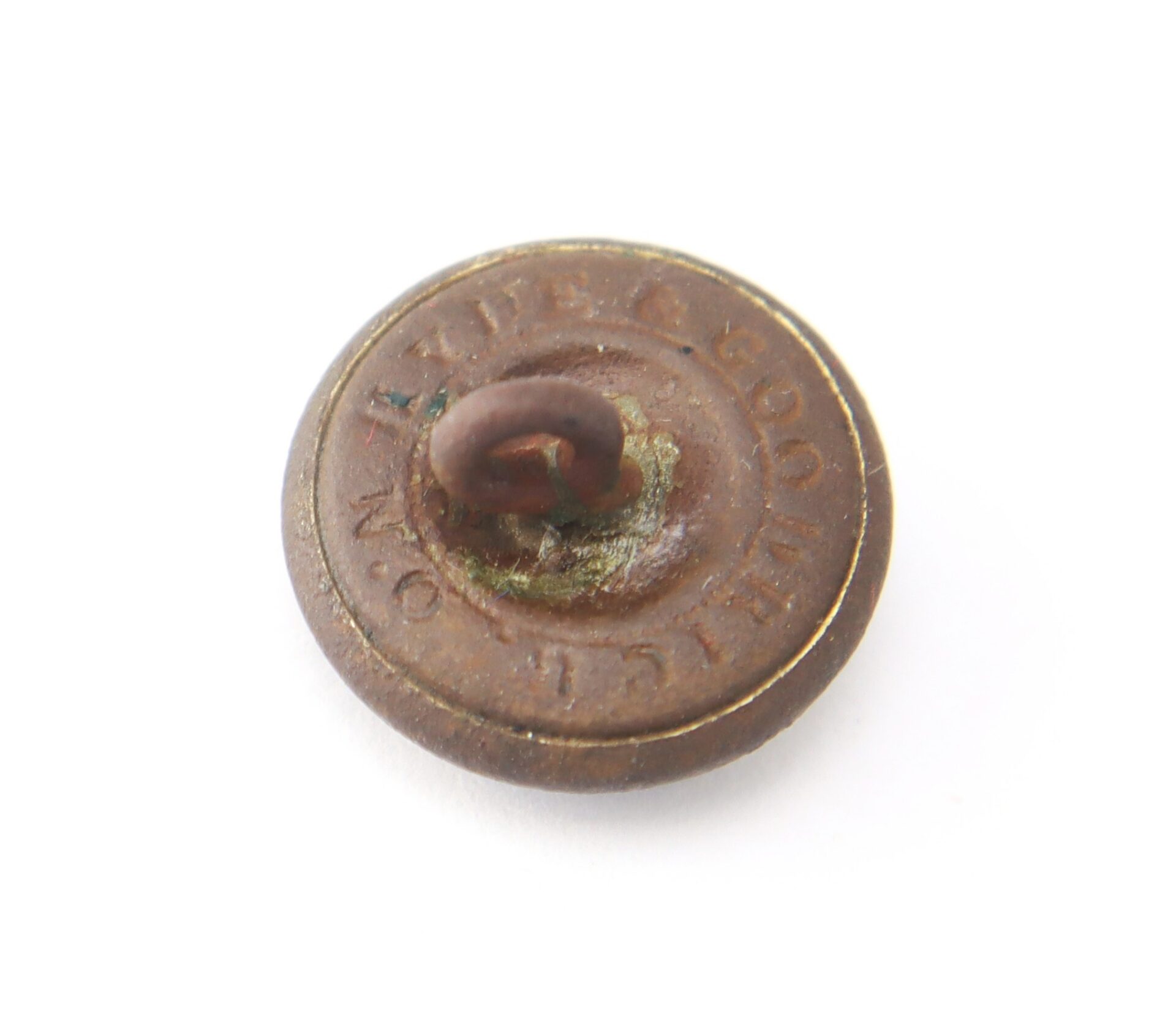 A round, weathered Mississippi Cavalry Button with a loop shank on the back and faint, partially legible engraved text around the edge, shown on a white background.