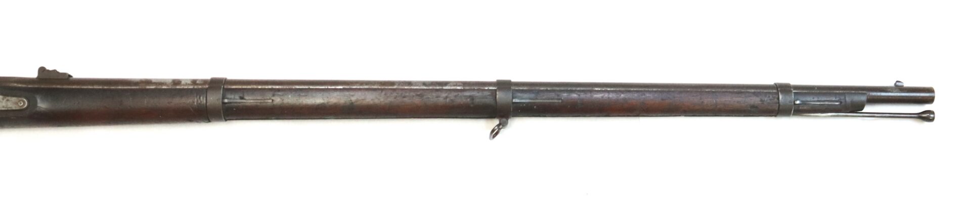 Long, antique wooden rifle with metal barrel and fittings, viewed from the side on a white background.