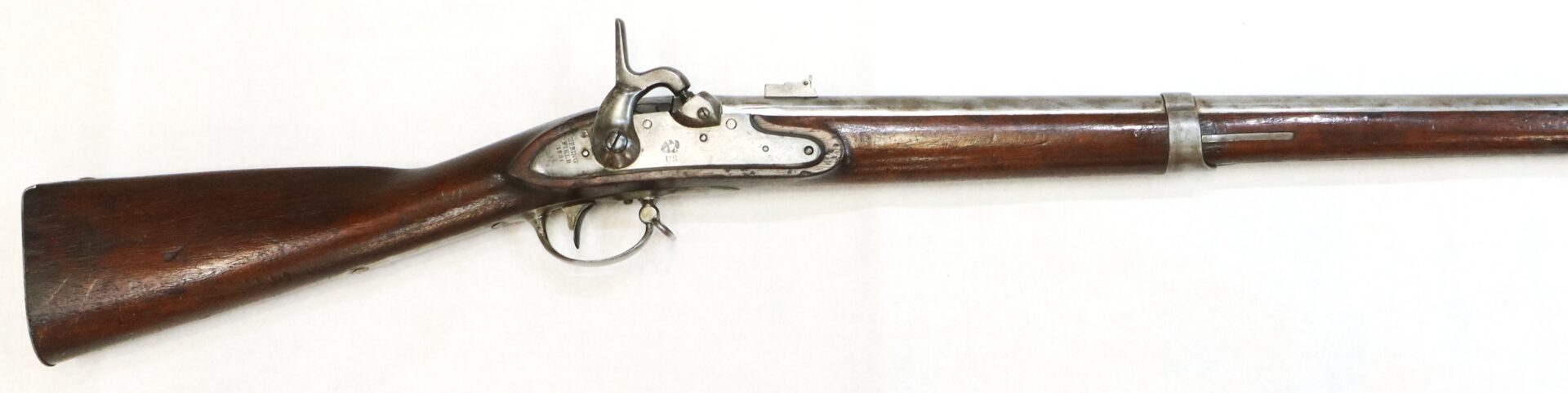An antique single-shot muzzle-loading rifle with a wooden stock and metal barrel, shown in a side view on a white background.