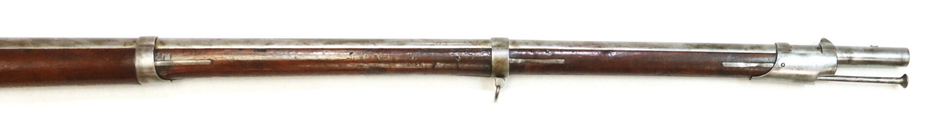 Partial view of an antique musket or rifle barrel with wooden stock and metal bands, showing the front sight and part of the muzzle.