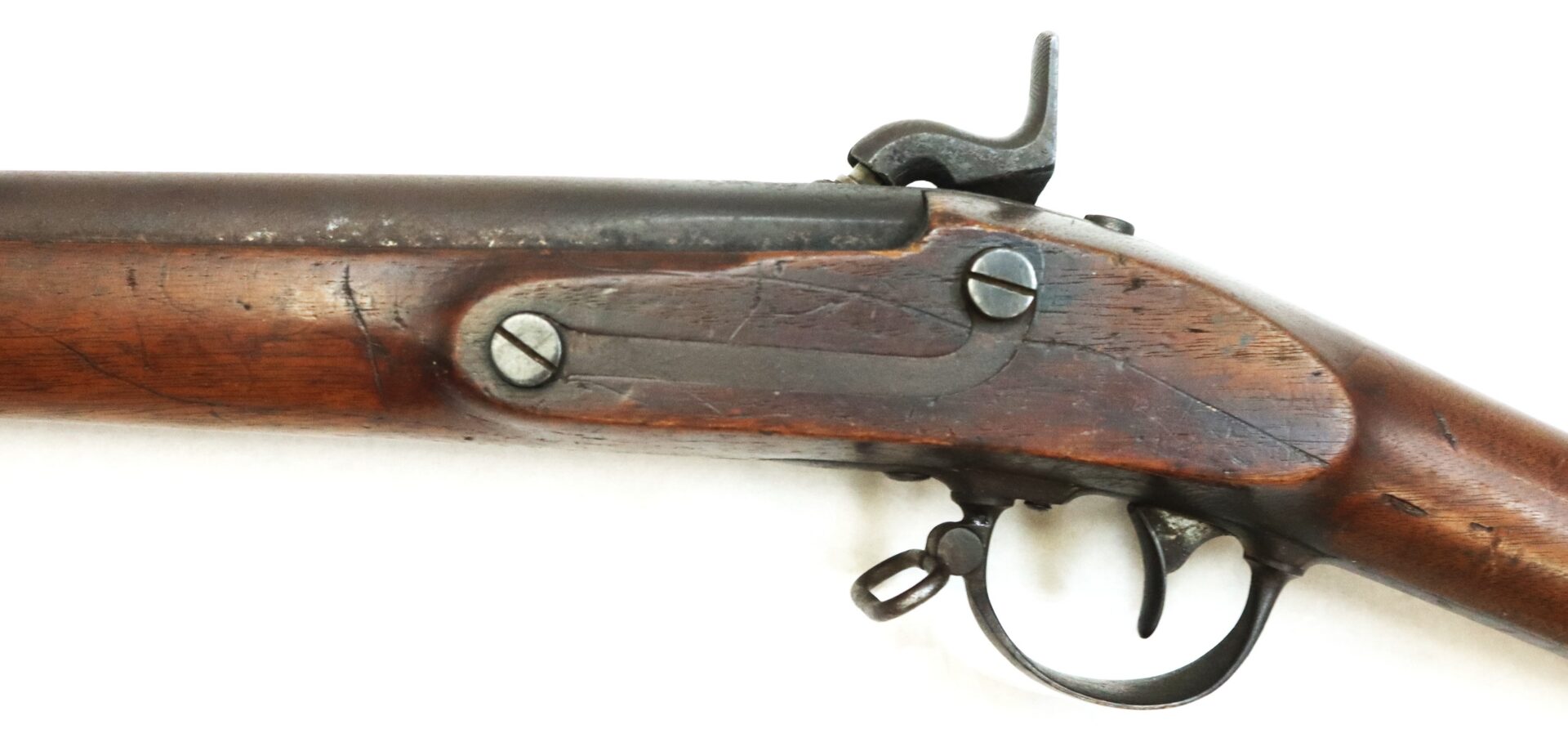 Close-up of the percussion lock, trigger guard, and wooden stock of a Model 1842 .69 Caliber Springfield Smoothbore Musket.