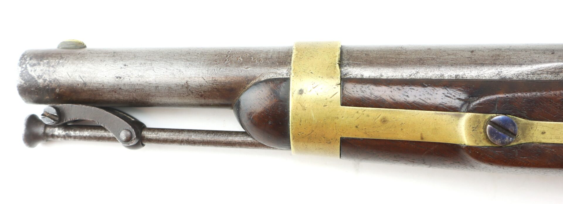Close-up of the muzzle and barrel of an antique musket with brass fittings and a metal ramrod attached underneath.