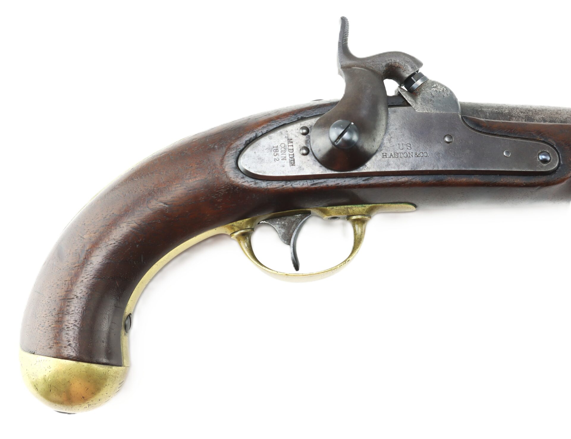 Side view of an antique percussion cap pistol with a wooden grip, brass trigger guard, and butt cap, showing the hammer and part of the barrel.