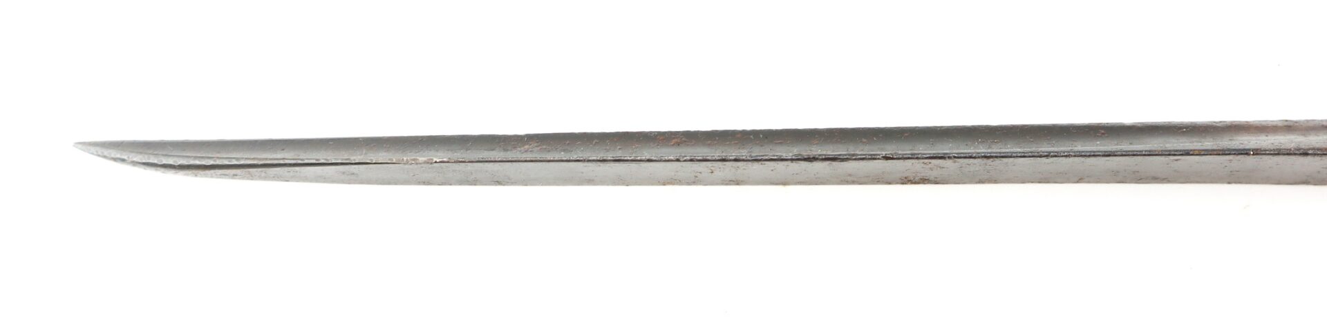 Close-up of the pointed tip of a metal blade or sword against a white background, showing some rust and wear.