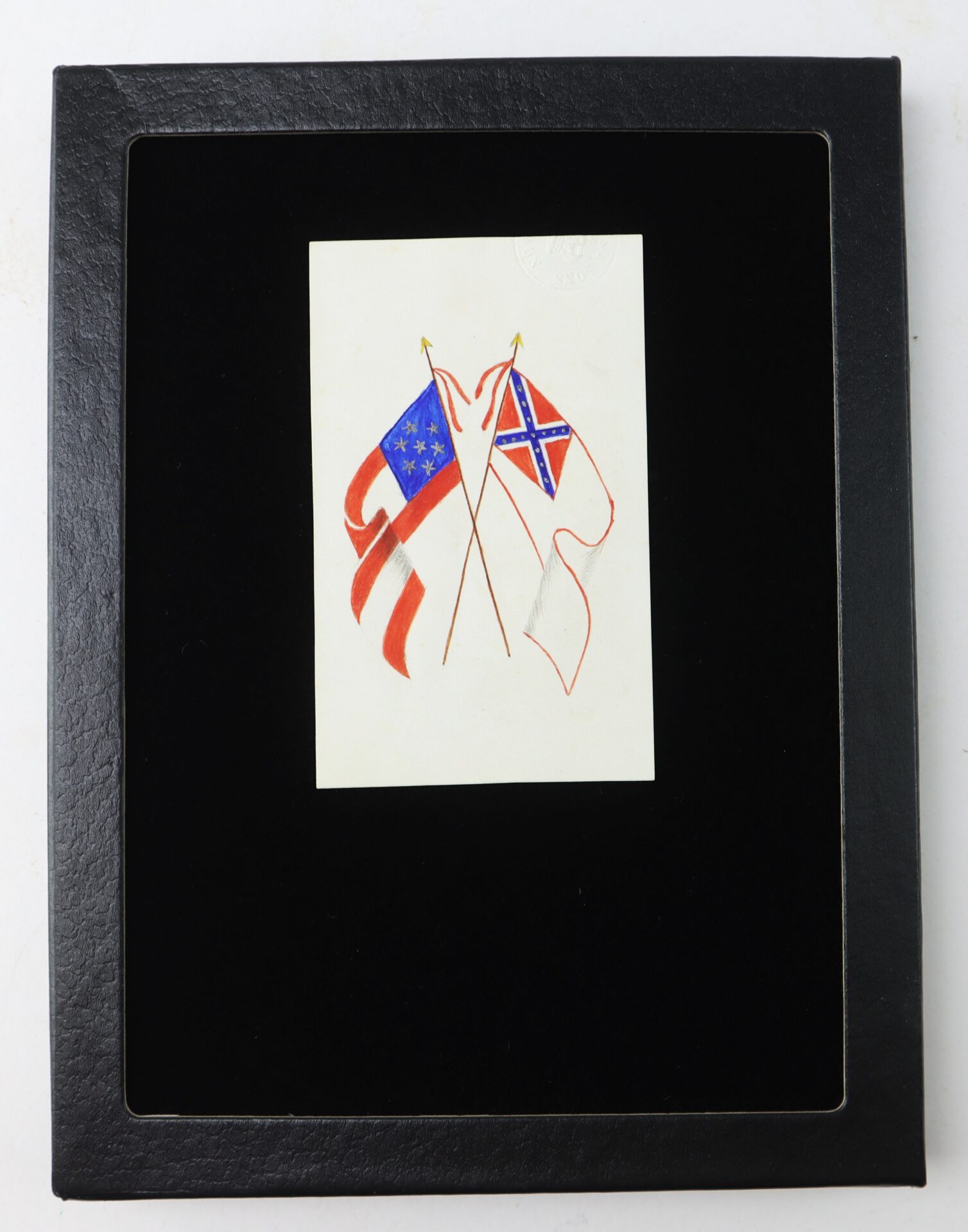 A black frame displays a white card with two crossed Confederate flags, each featuring different designs and colors, on a plain background.