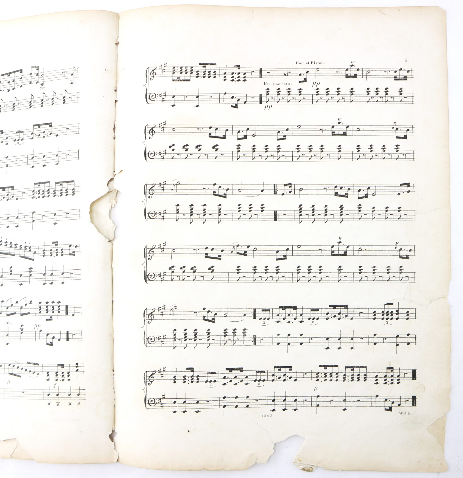 Two pages of aged, torn sheet music with visible piano notation, including treble and bass clefs, notes, dynamics, and the title “Grand Pilier” on the right page.