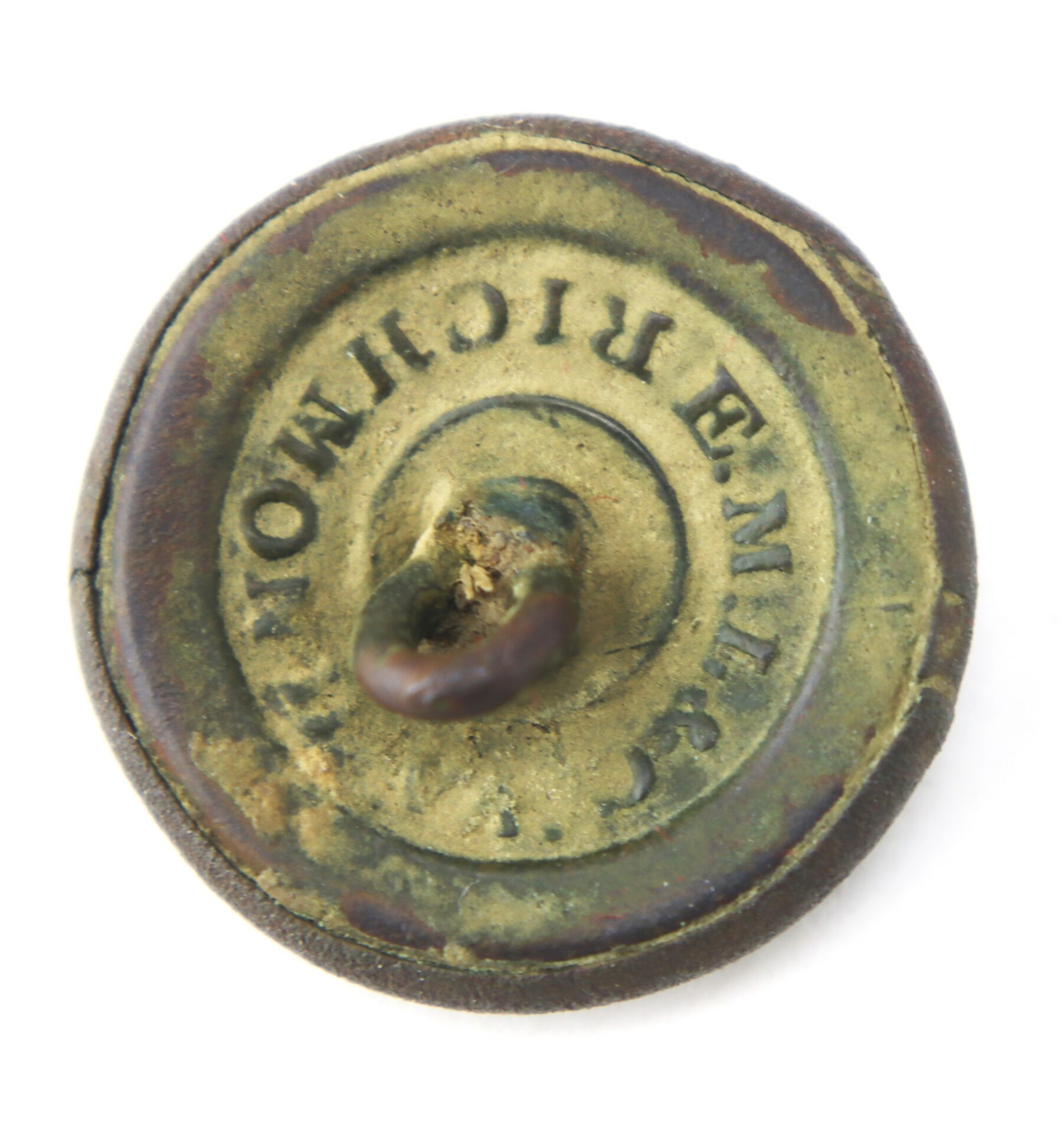 Round, aged metal button with a central loop and the engraved text “RICHMOND” partially visible around the edge.