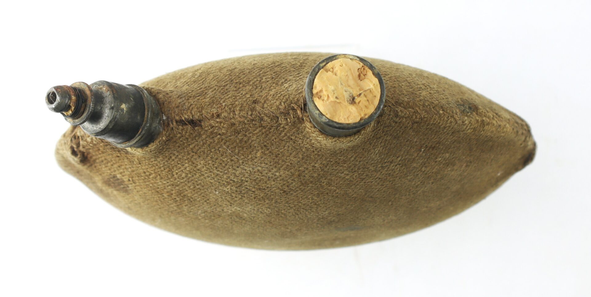 A vintage canteen with a fabric covering, metal spout, and cork stopper viewed from above against a white background.