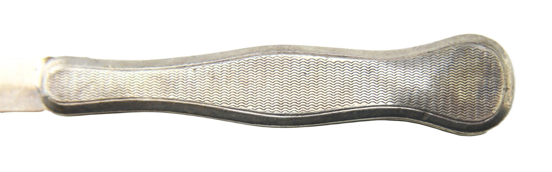 Close-up view of a metal knife handle with a textured, patterned grip, isolated on a white background.