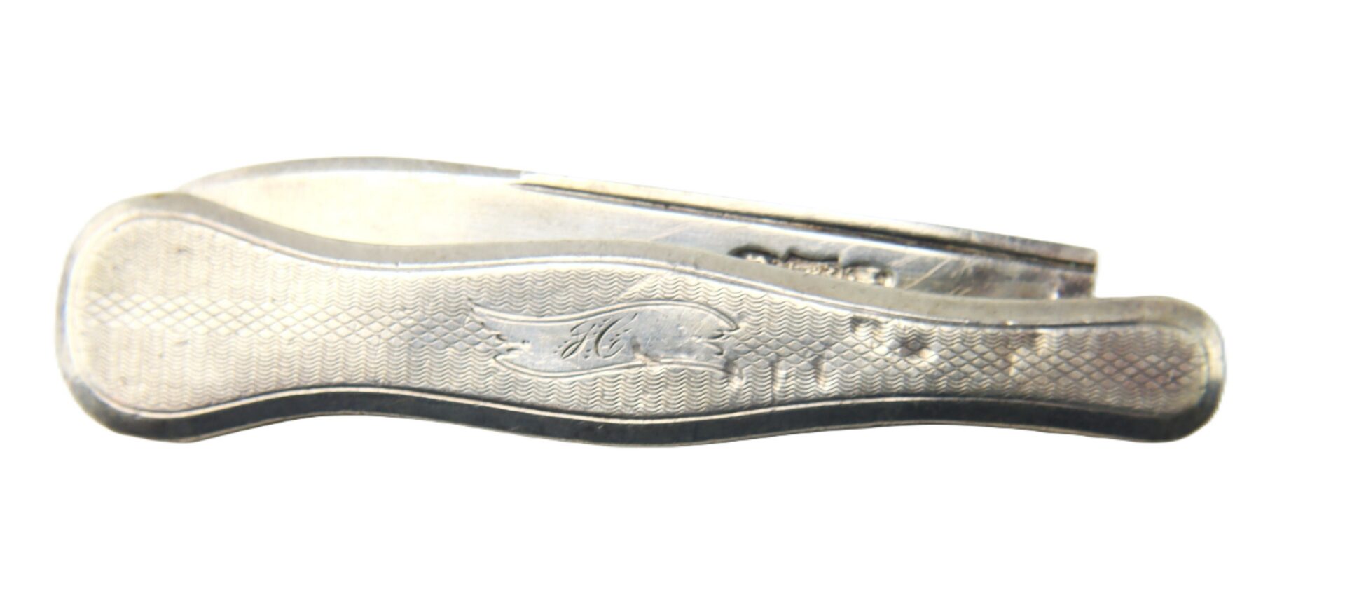 Closed silver pocket knife with a textured handle and engraved winged emblem, viewed from the side against a white background.