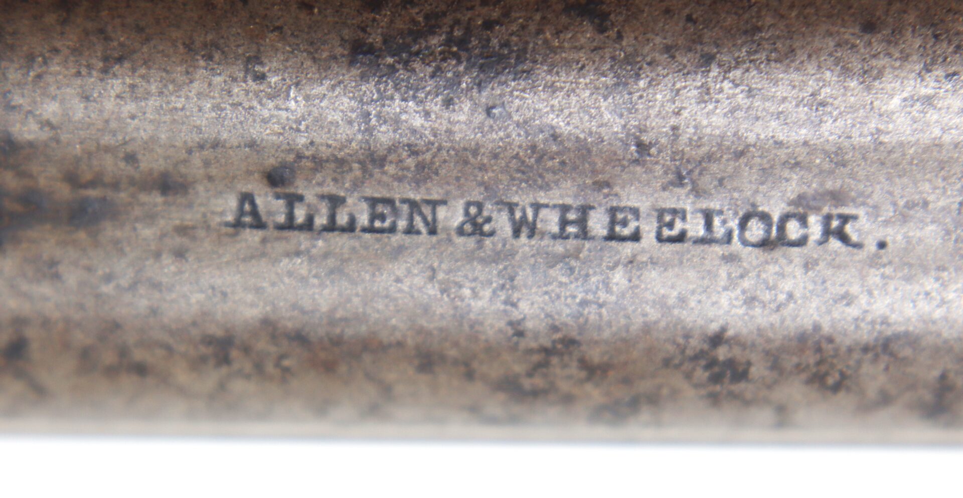 Close-up of a metal surface engraved with the text “ALLEN & WHEELOCK.”.