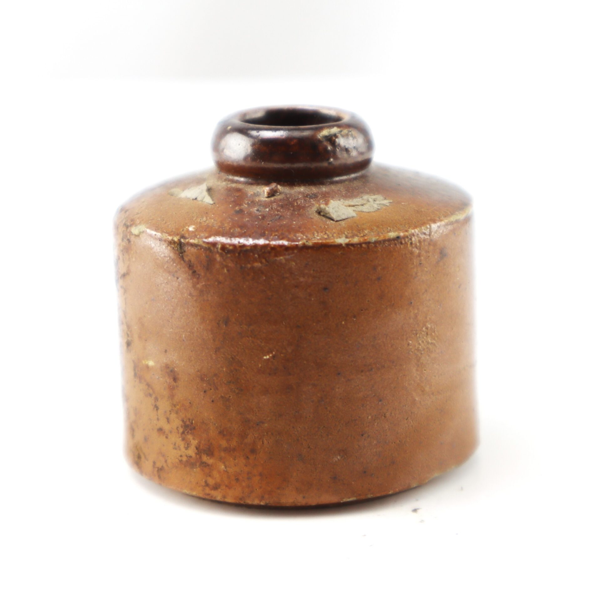 Small brown stoneware inkwell with a cylindrical body and a narrow rim.