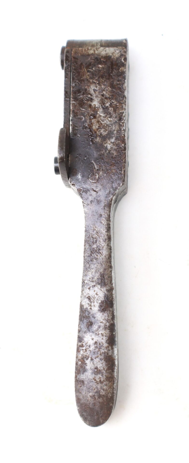 A rusted metal bullet mold.
