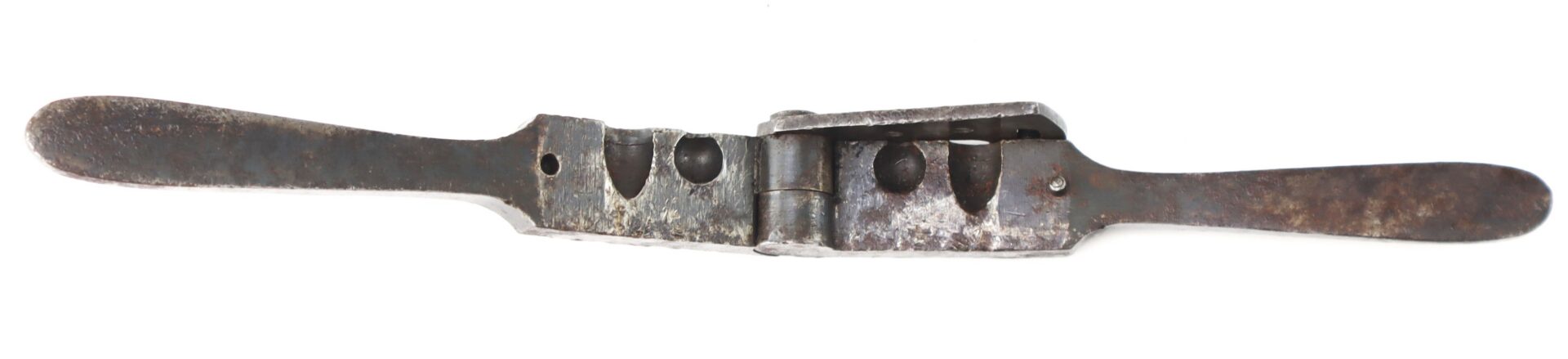 A vintage metal bullet mold with two handles.