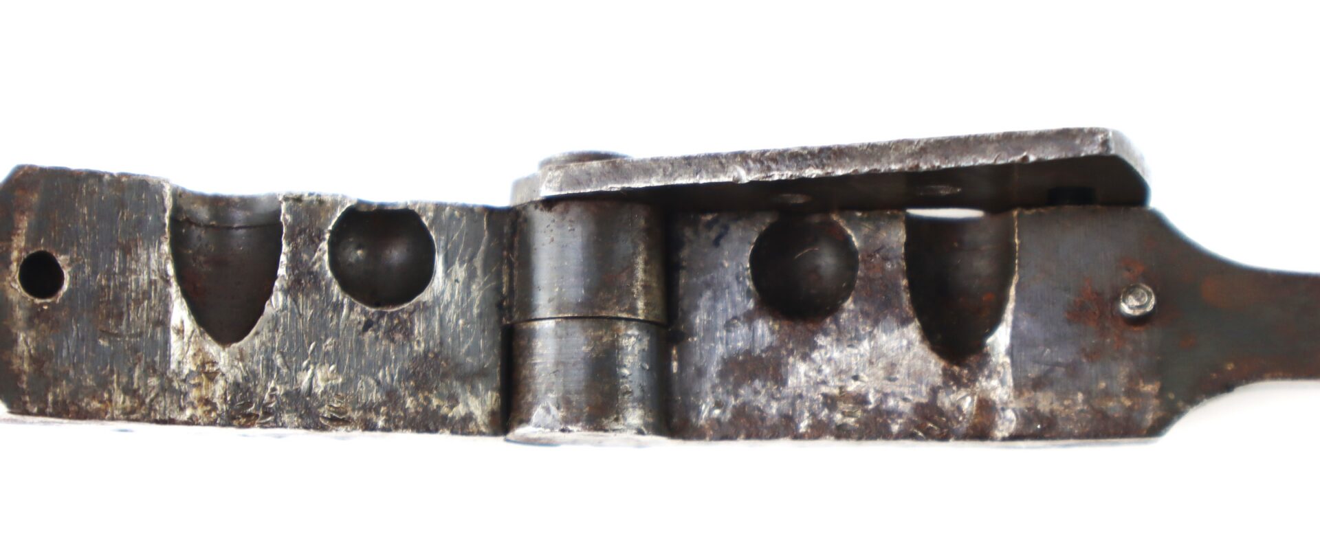 A vintage metal bullet mold with two circular cavities.