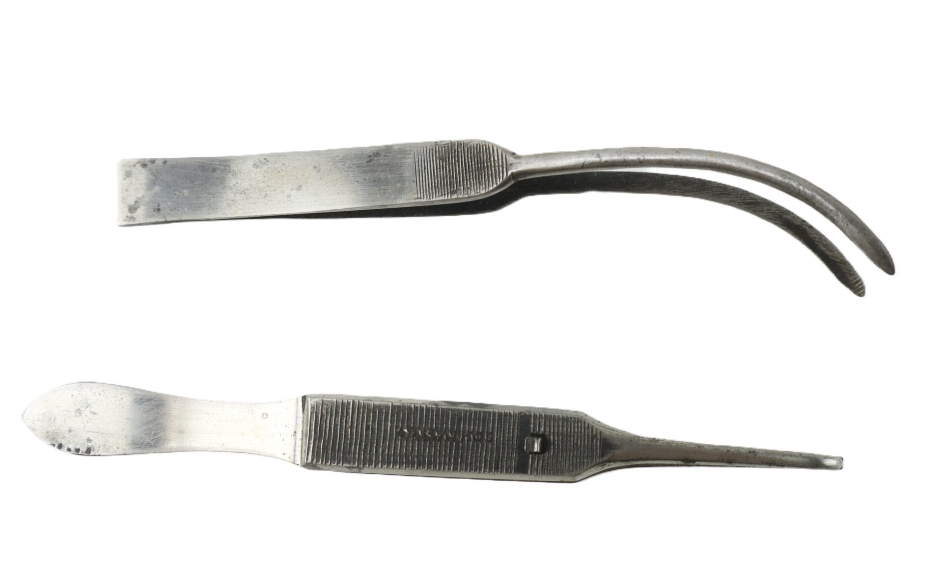 Two vintage metal surgical instruments, one with curved tips and one with a flat, rounded blade.
