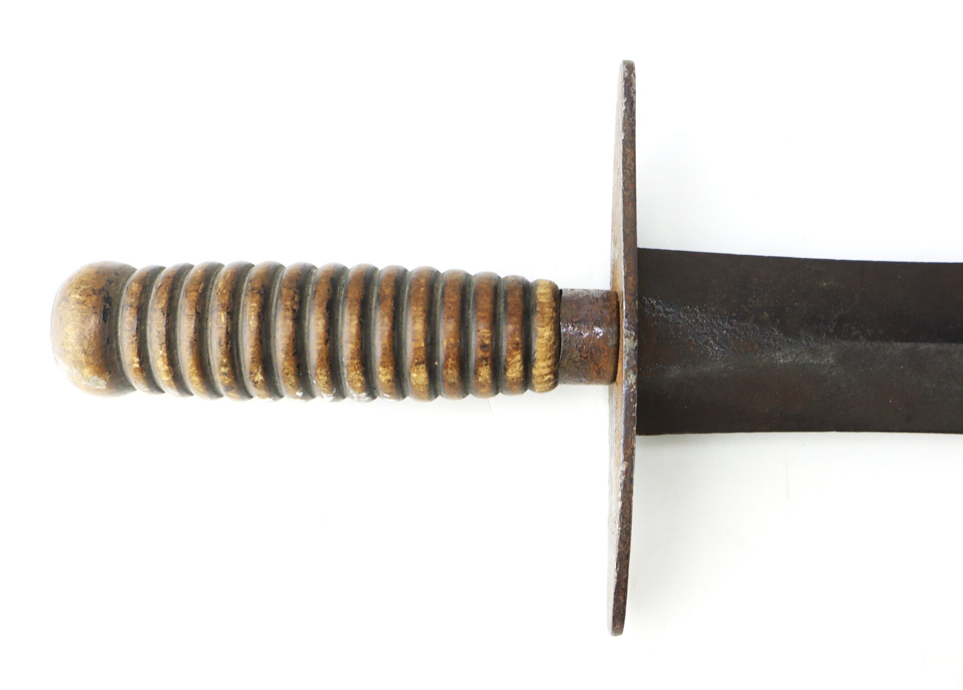 Close-up of a knife with a ribbed handle and a flat metal crossguard.